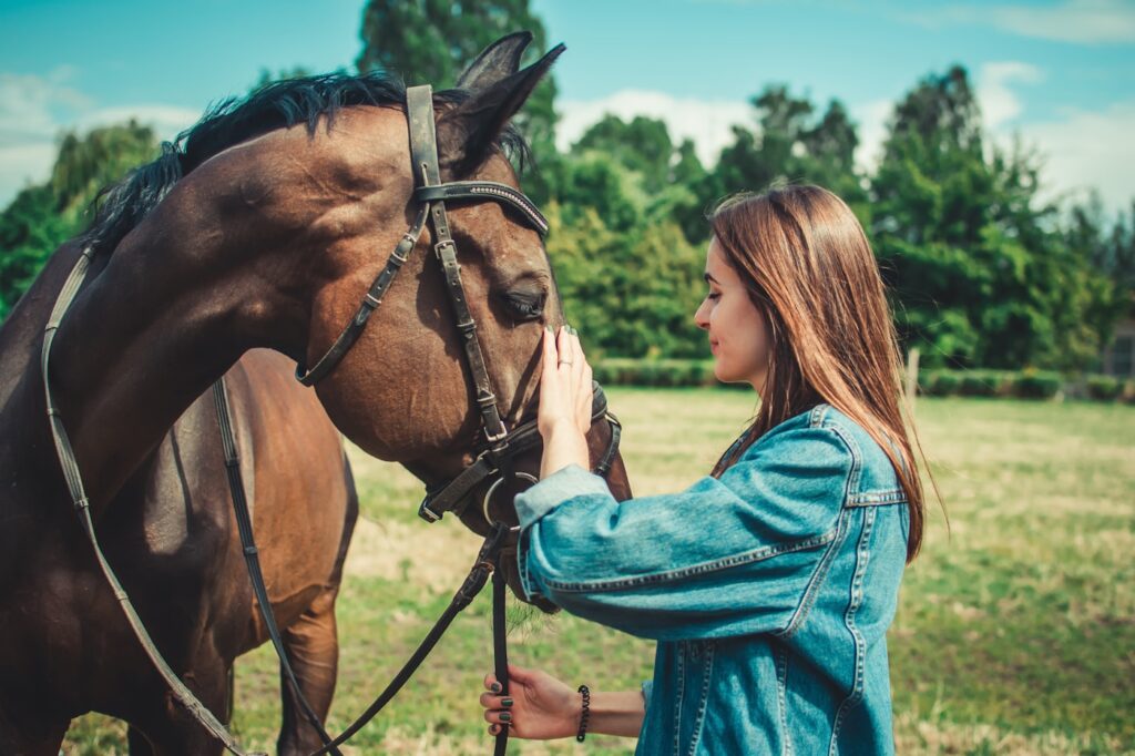 A person standing with a horse